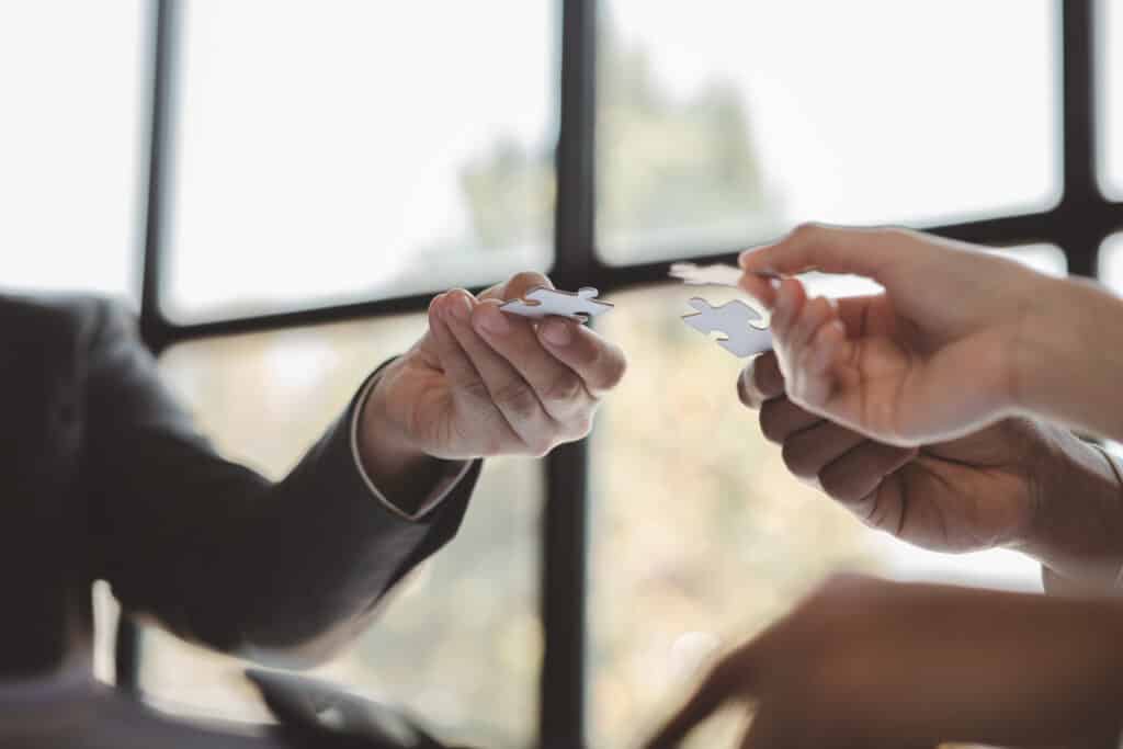 Group business people holding jigsaw puzzle together, share transfers